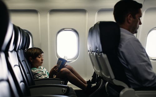 child reading on aeroplane
